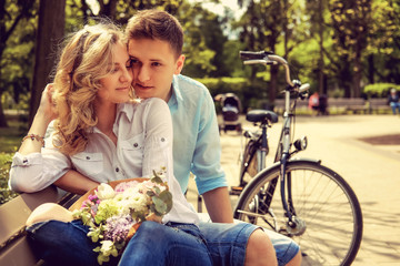 Happy man and cute blond woman with flowers.