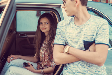 Loving couple posing near car