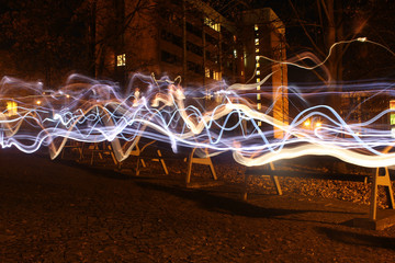 Light painting in the night city, abandoned benches in row