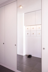 Fototapeta na wymiar White big closet with mirror
