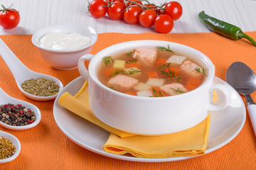 Salmon soup with carrot and potato seasoned with dill