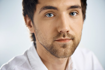 Close up portrait of elegant confident handsome young businessma