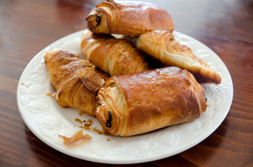 Croissants and Pain au chocolat on a plate