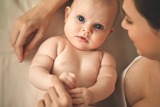 Happy mother with her baby on the badroom