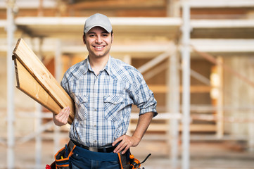 Portrait of a smiling carpenter in a construction site