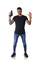 Handsome man with gun holding raised arms