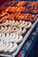 rows of bratwurst on a large grill