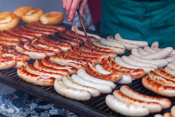 Fototapeta rows of bratwurst on a large grill obraz