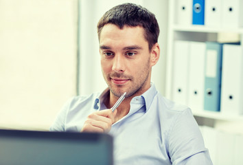 young businessman with laptop computer at office