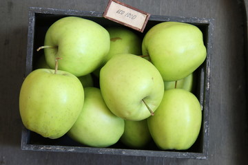 Eco food idea, green apples on a black table and text