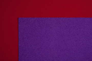 Fototapeta premium Eva foam ethylene vinyl acetate sponge plush purple surface on red smooth background