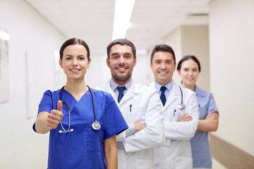 medics or doctors at hospital showing thumbs up