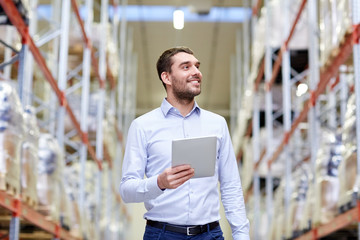 happy businessman with tablet pc at warehouse - obrazy, fototapety, plakaty