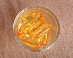 Fish oil capsules  on wooden  background