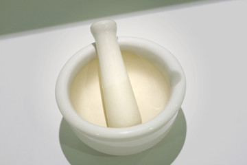 White mortar  and  pestle for grinder.