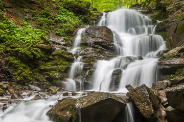 Fototapeta na wymiar Wonderlust waterfall at the mountains.
