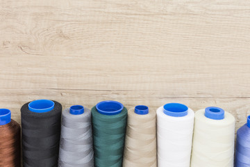 Several spools of thread of different colors and sizes
