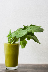 Healthy green detox with spinach, cucumber, lime and apples on a rustic wooden table
