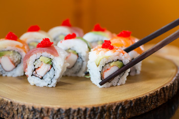 Sushi set, sushi roll with shrimp and sushi roll with avocado.