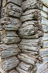 Old wooden wall made of brown logs