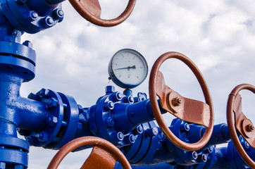 Wellhead with valves and manometer. Oil and gas concept. - obrazy, fototapety, plakaty