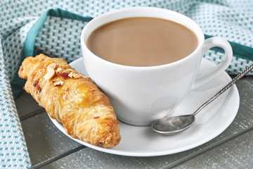 Coffee with milk and croissant