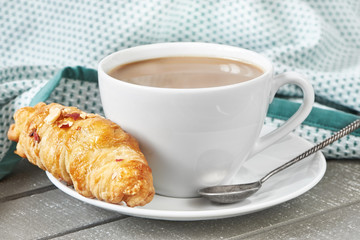 Coffee with milk and croissant