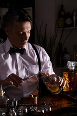 Young man working as a bartender in a nightclub/cocktail bar