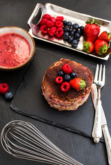 homemade tiamisu of berry fruits with whisk in the foreground