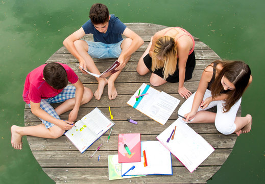 Gruppe Jugendliche lernen gemeinsam draußen am See