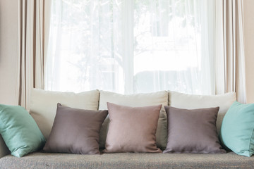 modern sofa and set of pillows in modern bedroom