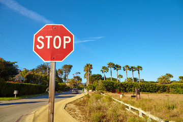Stop sign by the empty road