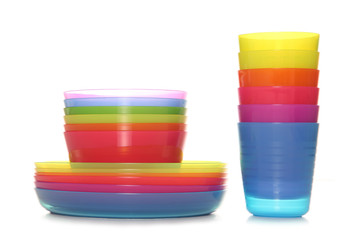 stack of colourful plastic cups bowls and plates
