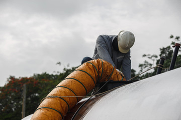 Worker blow fresh air into vessel