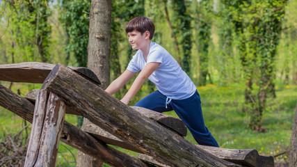 Fototapeta premium Cute boy in the park playing 