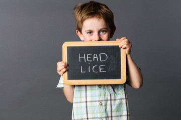 ashamed preschool boy informing about head lice at school