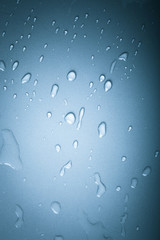 Drops of water on a color background. Blue. Shallow depth of fie