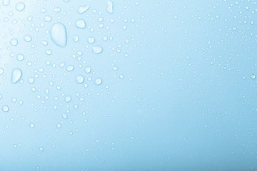 Drops of water on a color background. Blue. Shallow depth of fie - obrazy, fototapety, plakaty