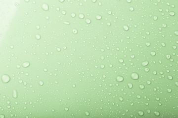 Drops of water on a color background. Green. Shallow depth of fi