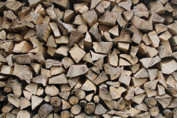 Pile of firewood. Preparation of firewood for the winter.