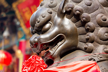 Lion statue in front of chinese temple