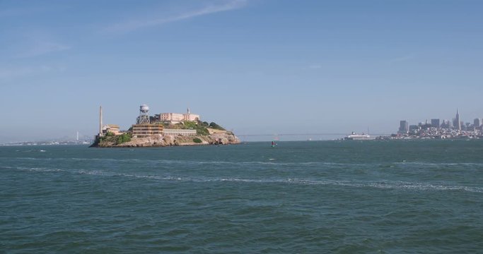 Boat view from water of Alcatraz and city of San Francisco in background.
