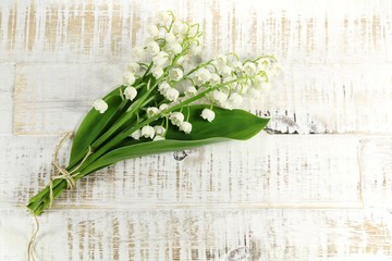 bunch of lily-of-the-valley on wooden background