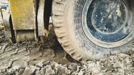 Big excavator wheels covered with mud