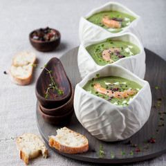 Broccoli, spinach cream soup, shrimp, wooden board