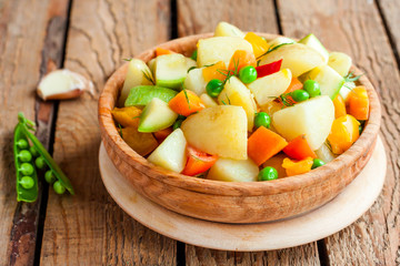 stewed summer vegetables in a wooden bowl