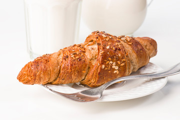 croissant cereal with milk glass