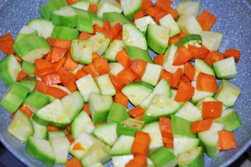 Vegetable ragout on pan. Stewed zucchini, tomatoes, carrot and p