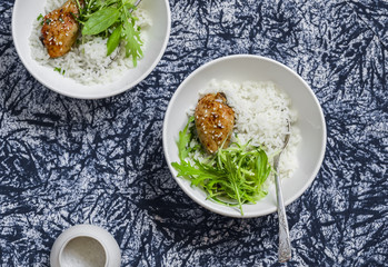 Rice, chicken and salad in a bowl on a dark  background. Healthy delicious food