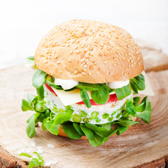 Vegetarian burger with egg, pea patty, fresh salad